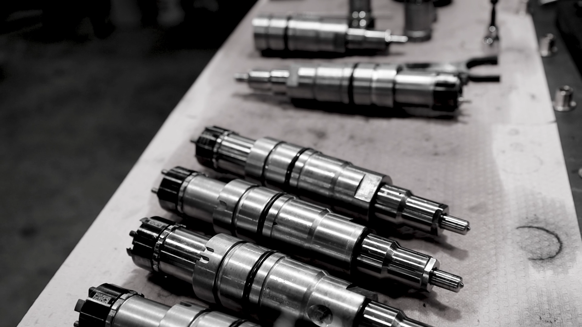 Heavy duty diesel injectors lined up for calibration and testing.