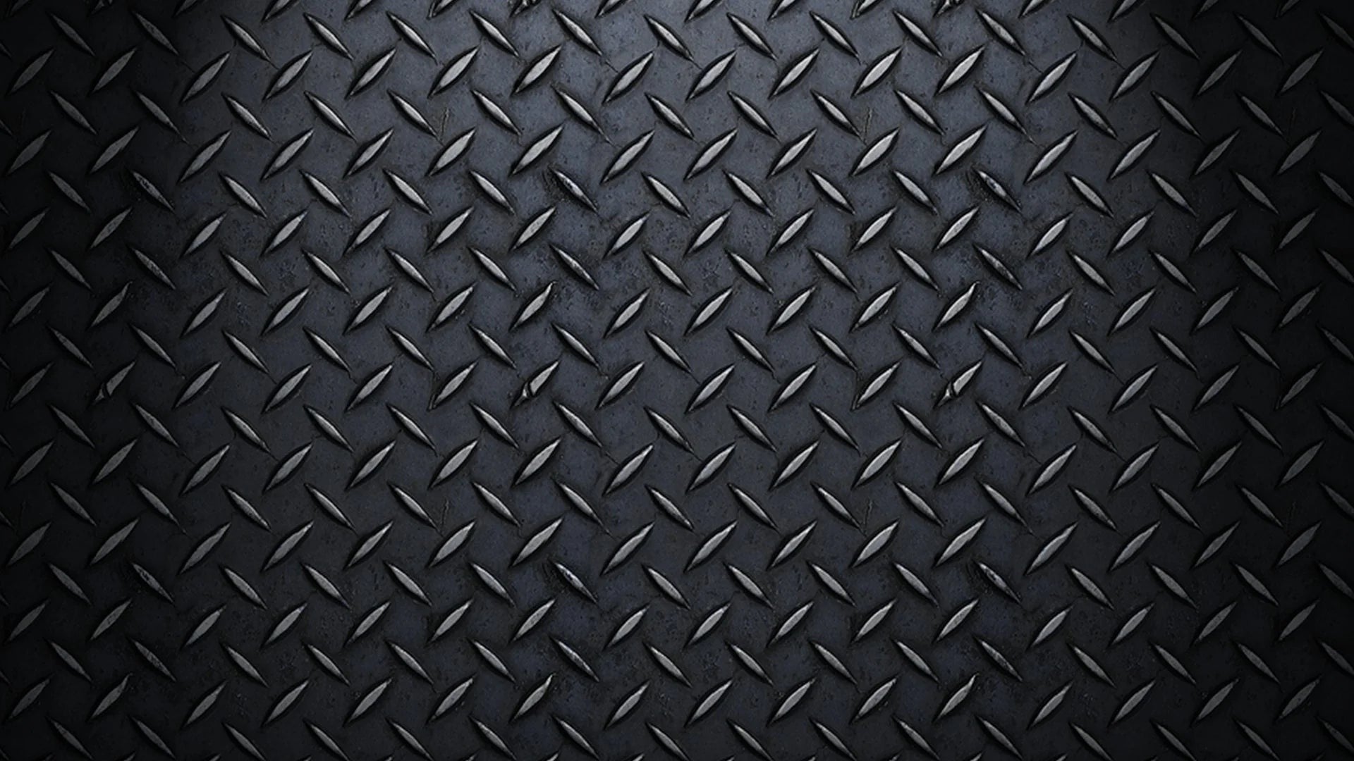 Textured black metal surface with diamond pattern.